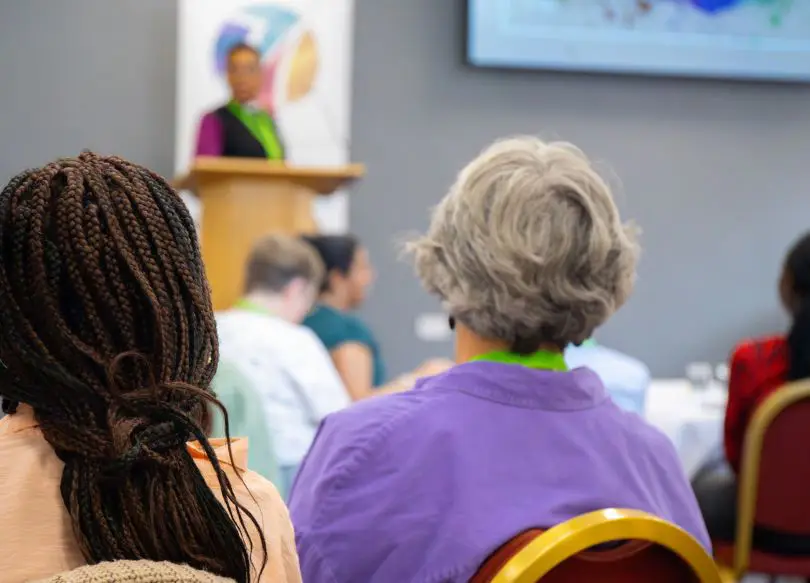 People listening to a speaker in a meeting