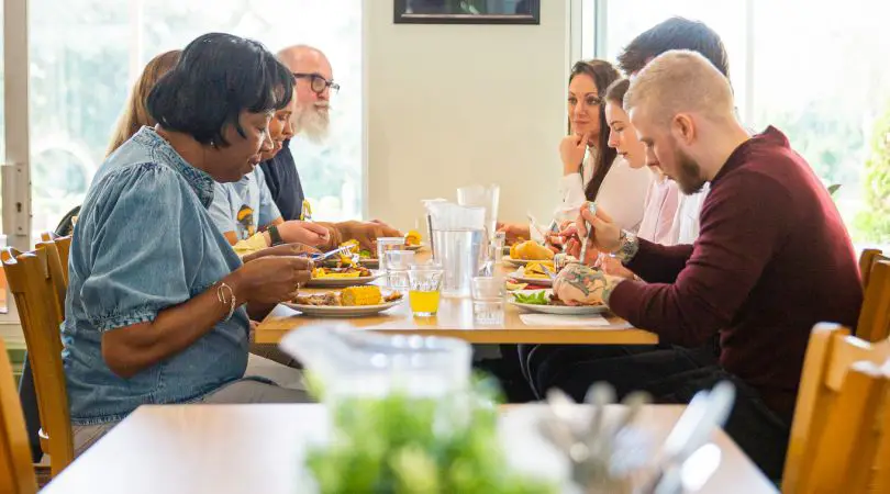A large group sitting around a table eating