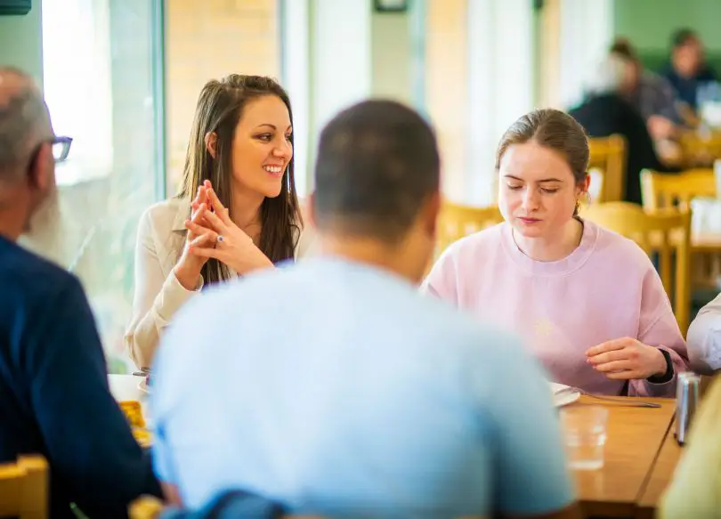 A family group sitting around a table