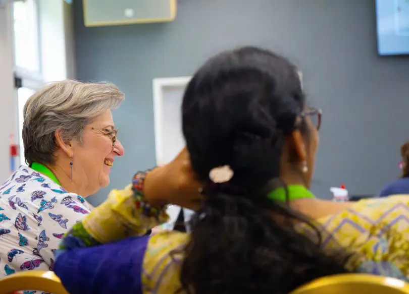 A couple of women in a meeting room