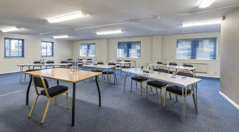 Spacious meeting room with table and chairs