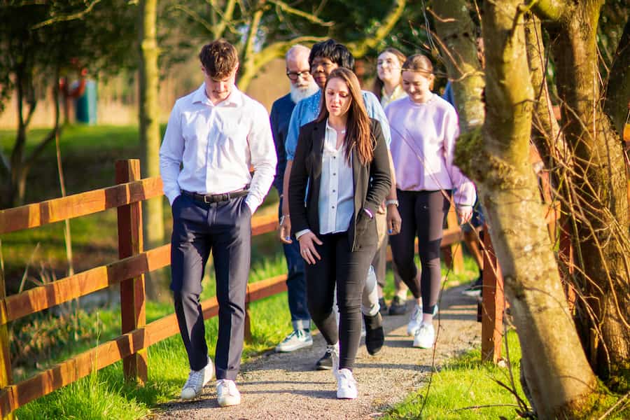 A group going for a walk around the lake at The Hayes Centre.