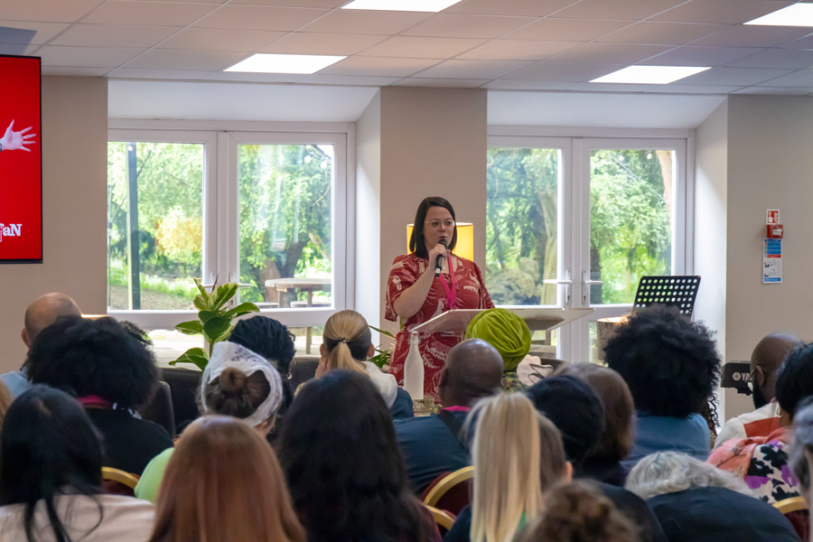A woman doing a training session at a conference in the Yew Tree Hall at High Leigh Conference Centre.