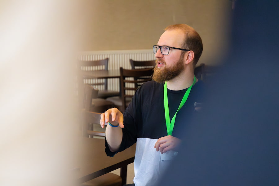 A man at a conference talking about their conference theme.