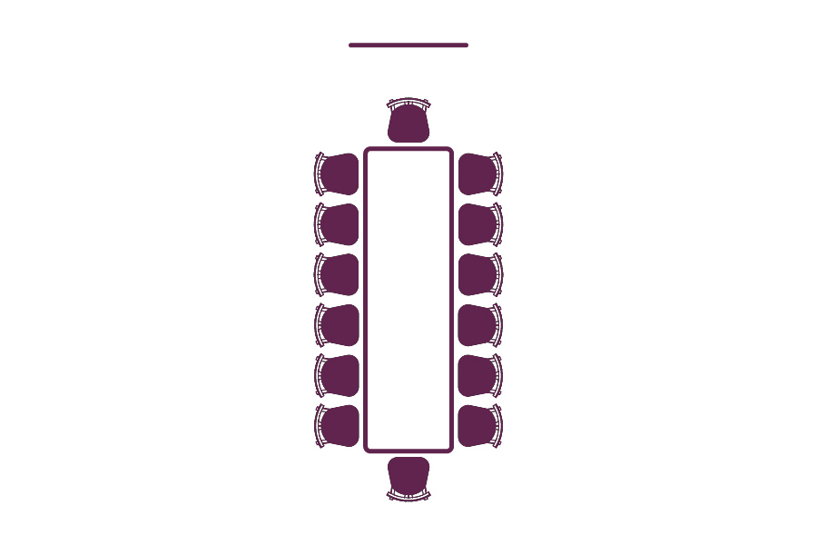A diagram showing chairs around a table with a screen on the top end, displaying boardroom style.
