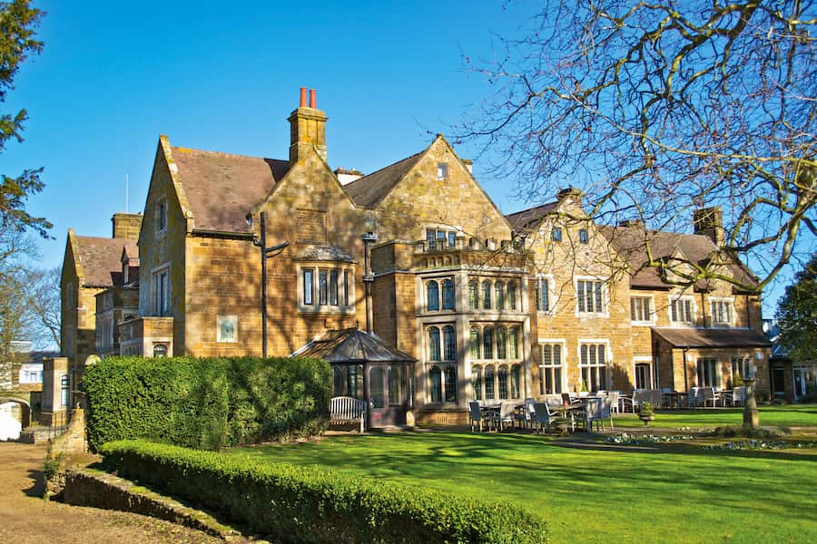 Highgate house during a winter afternoon with blue sky, green grass, and the splendour of the old architecture.