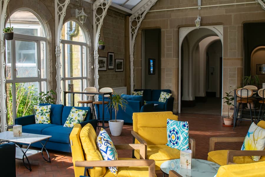 A view of the vinery showing the colourful furniture and the passage way leading through to the Lounge.