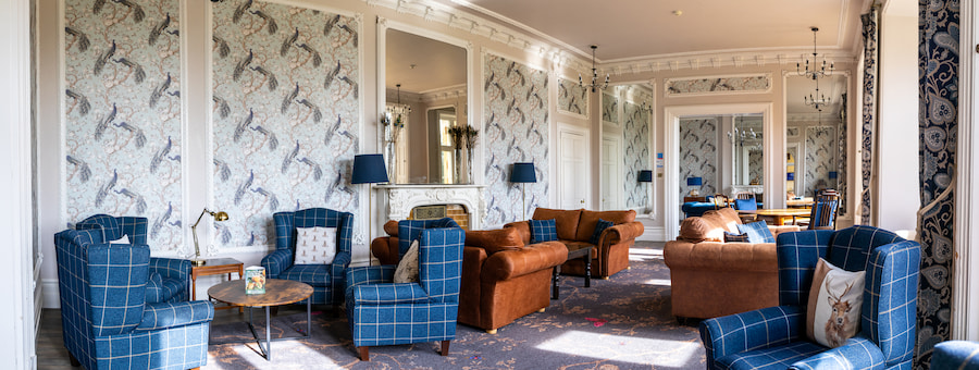 The Woodlands lounge showing the colourful furniture and woodlands-themed d&eacute;cor. 