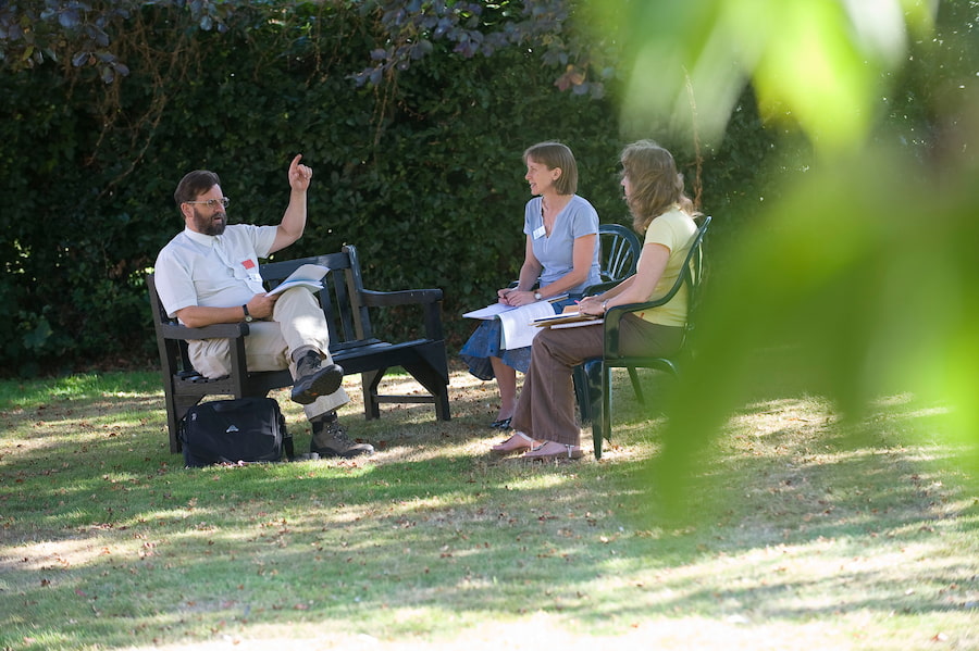 3 leaders sitting outside in the beautiful grounds of one of our conference centres.