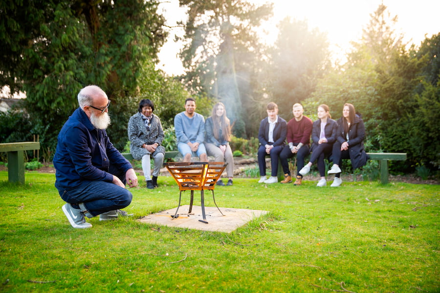 A group standing around the firepits.