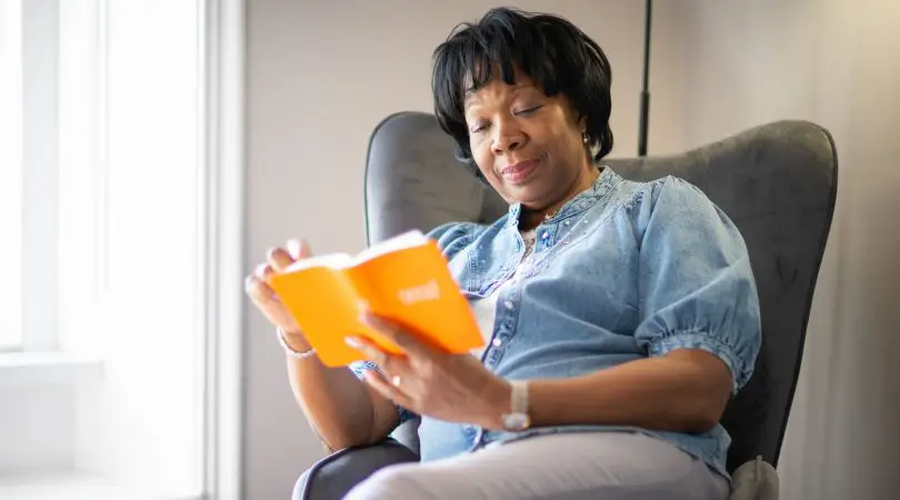 Woman sitting in chair reading