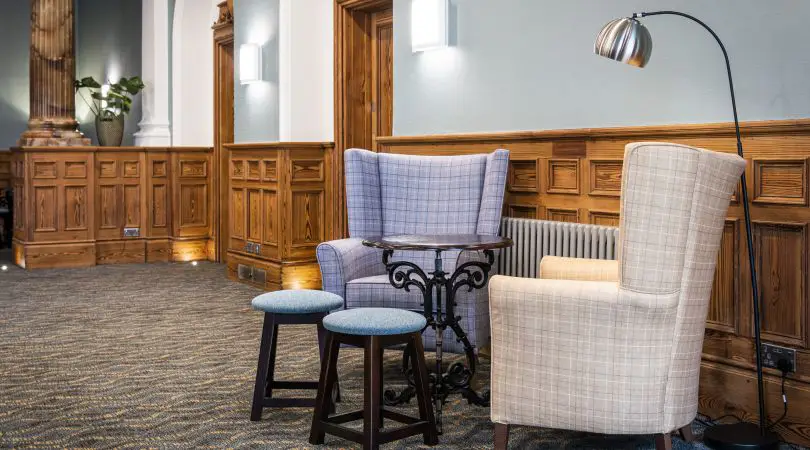 A couple of comfortable armchairs and a reading lamp